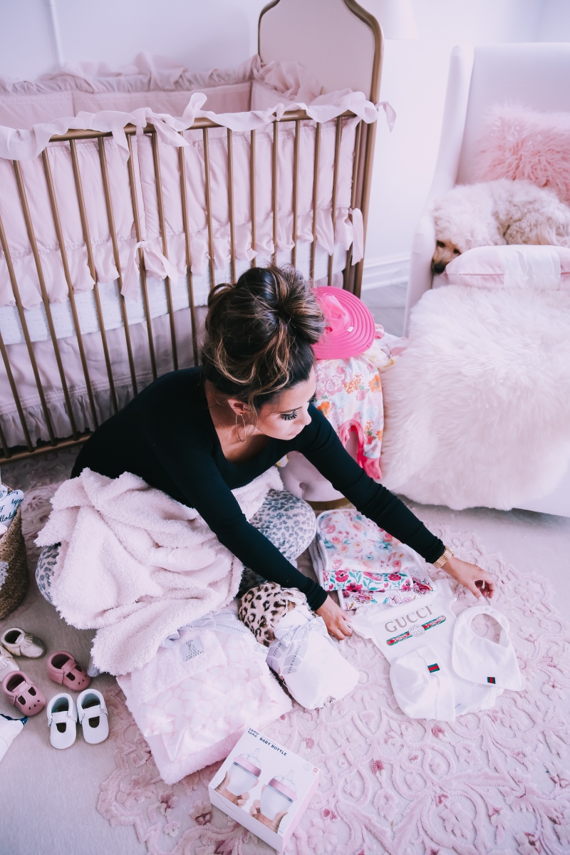 Emily Ann Gemma of The Sweetest Thing Blog in baby girl nursery. Baby Gucci outfit.