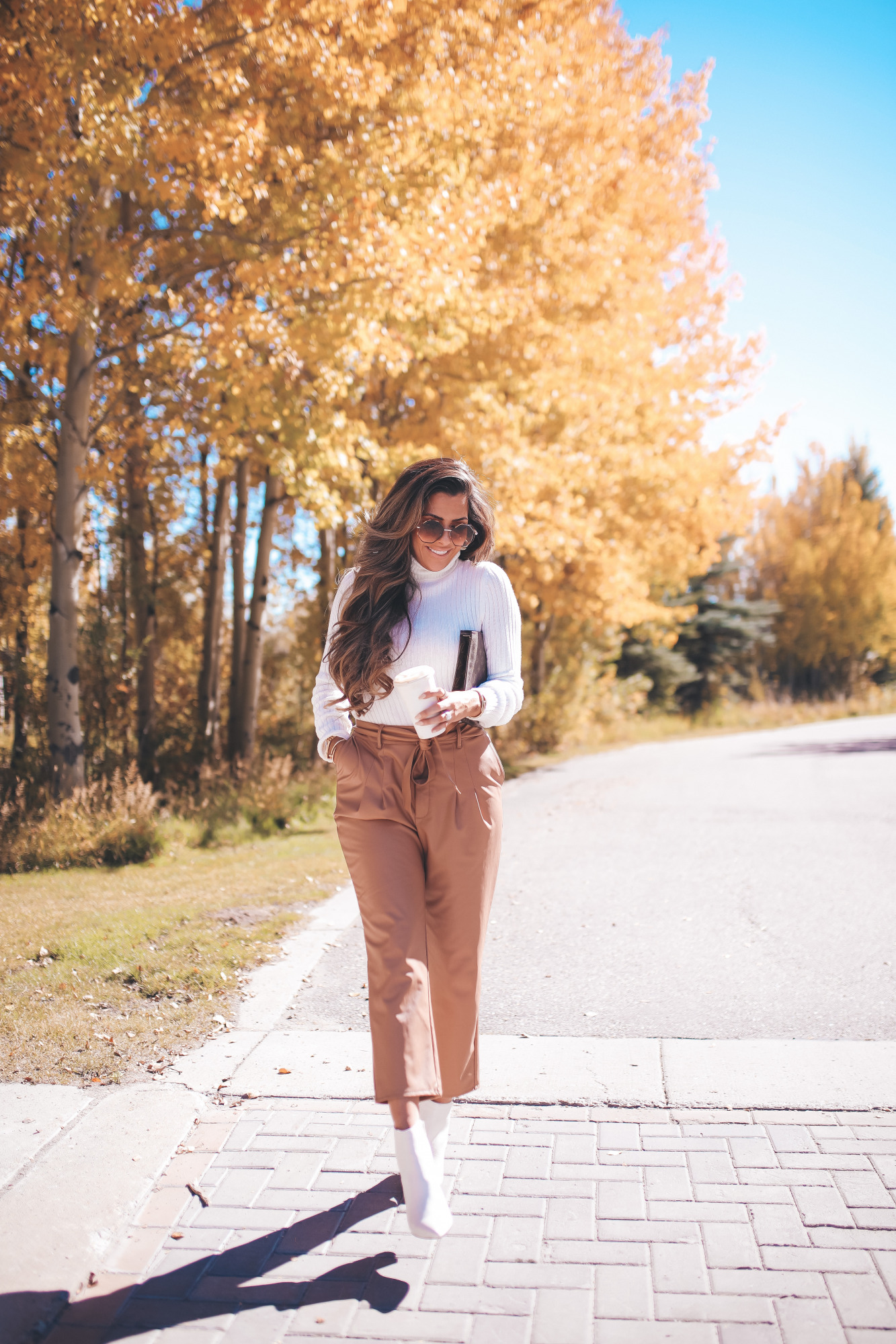 fall fashion outifit ideas pinterest 2020, fall fashion express 2020, fall outfits white booties, emily gemma2 |Fall Outfits by popular US fashion blog, The Sweetest Thing: image of Emily Gemma outside in Jackson Hole and wearing a Express Wide Ribbed Turtleneck Sweater, Express Super High Waisted Vegan Leather Belted Ankle Pant, Express Snakeskin Textured Block Heel Booties, Express Small Twisted Hoop Earrings, and Express Octagon Cut-Out Sunglasses.