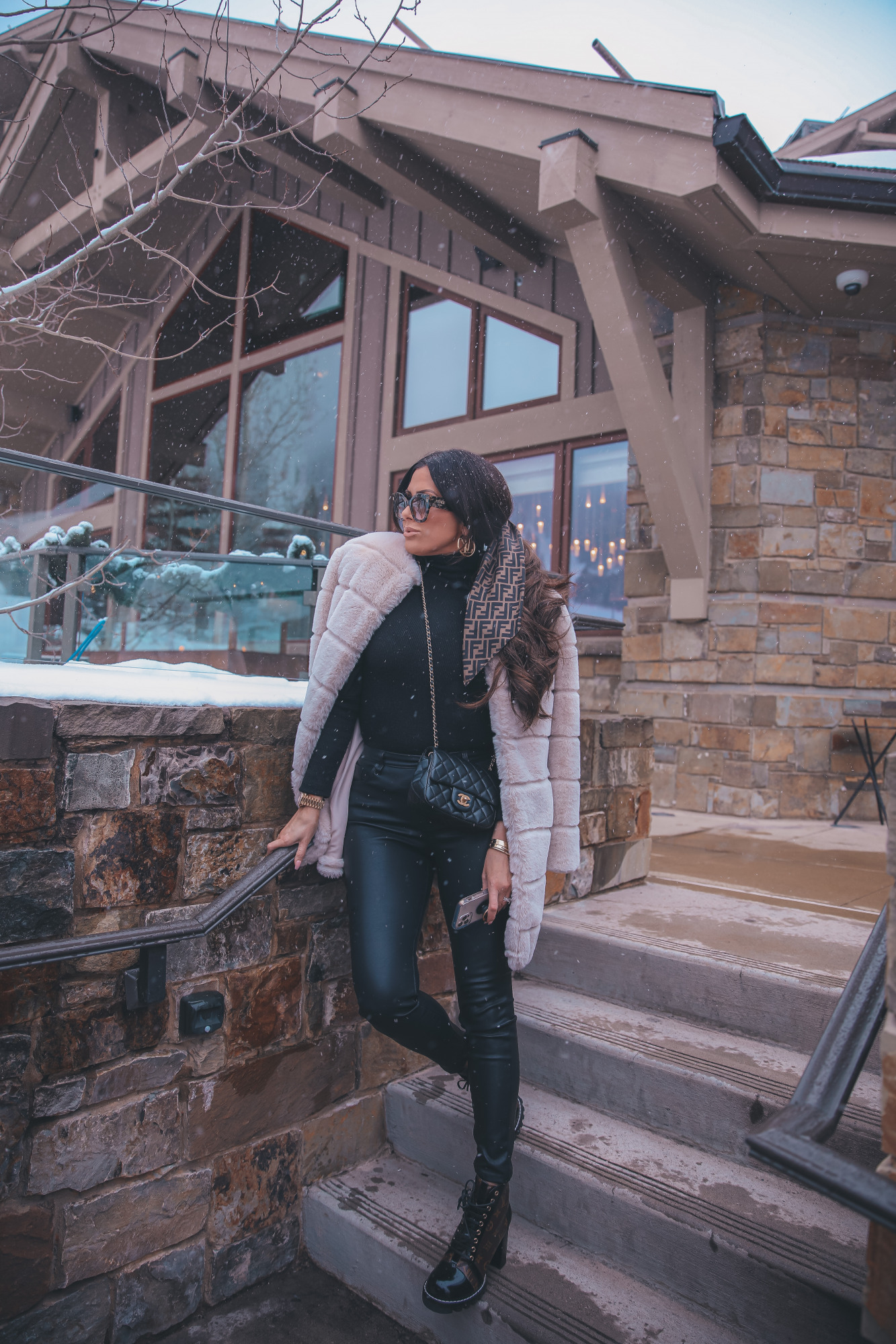 fendi hair scarf scrunchie, Louis Vuitton Star Trail Ankle Boot, Louise Hoop Earrings, Fendi Roma Sunglasses, Emily Gemma, the sweetest thing blog |Jackson Hole Winter by popular US fashion blog, The Sweetest Thing: image of Emily Gemma wearing a BB Dakota tan faux fur coat, black Express ruffle shoulder top, Fendi sunglasses, Black BlankNYC faux leather leggings, Louis Vuitton boots, Fendi hair scarf, Louis Vuitton earrings, and a Chanel black quilted purse.