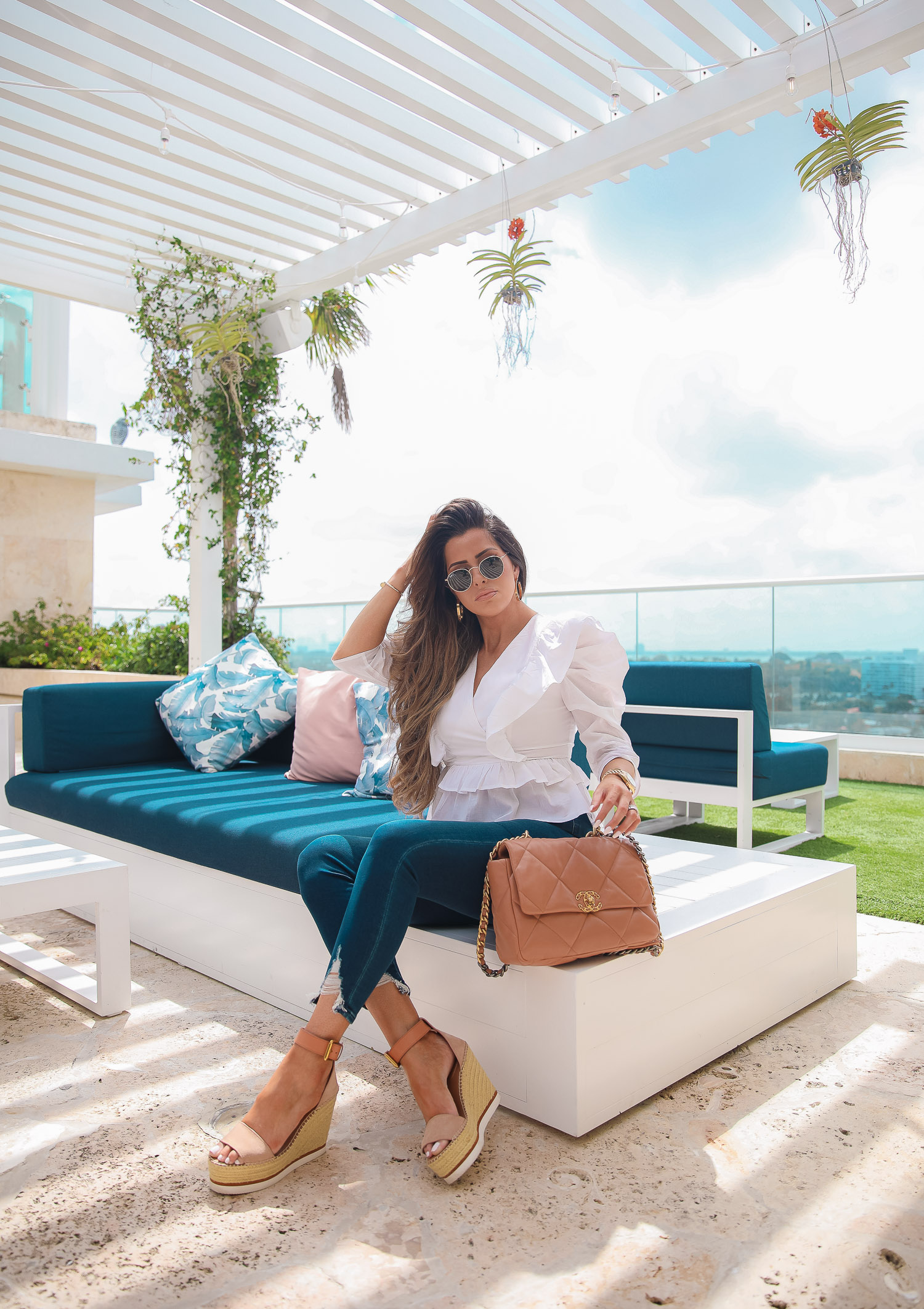 EXPRESS spring fashion, good american jean dupes, chanel 19 medium tan carmel color, emily gemma, the grand miami surfside |Spring Fashion by popular US fashion blog, The Sweetest Thing: image of Emily Gemma wearing a Express white white ruffle and puff sleeve top, Express Jeans, Espadrille sandals, and holding a Chanel 19 bag. 