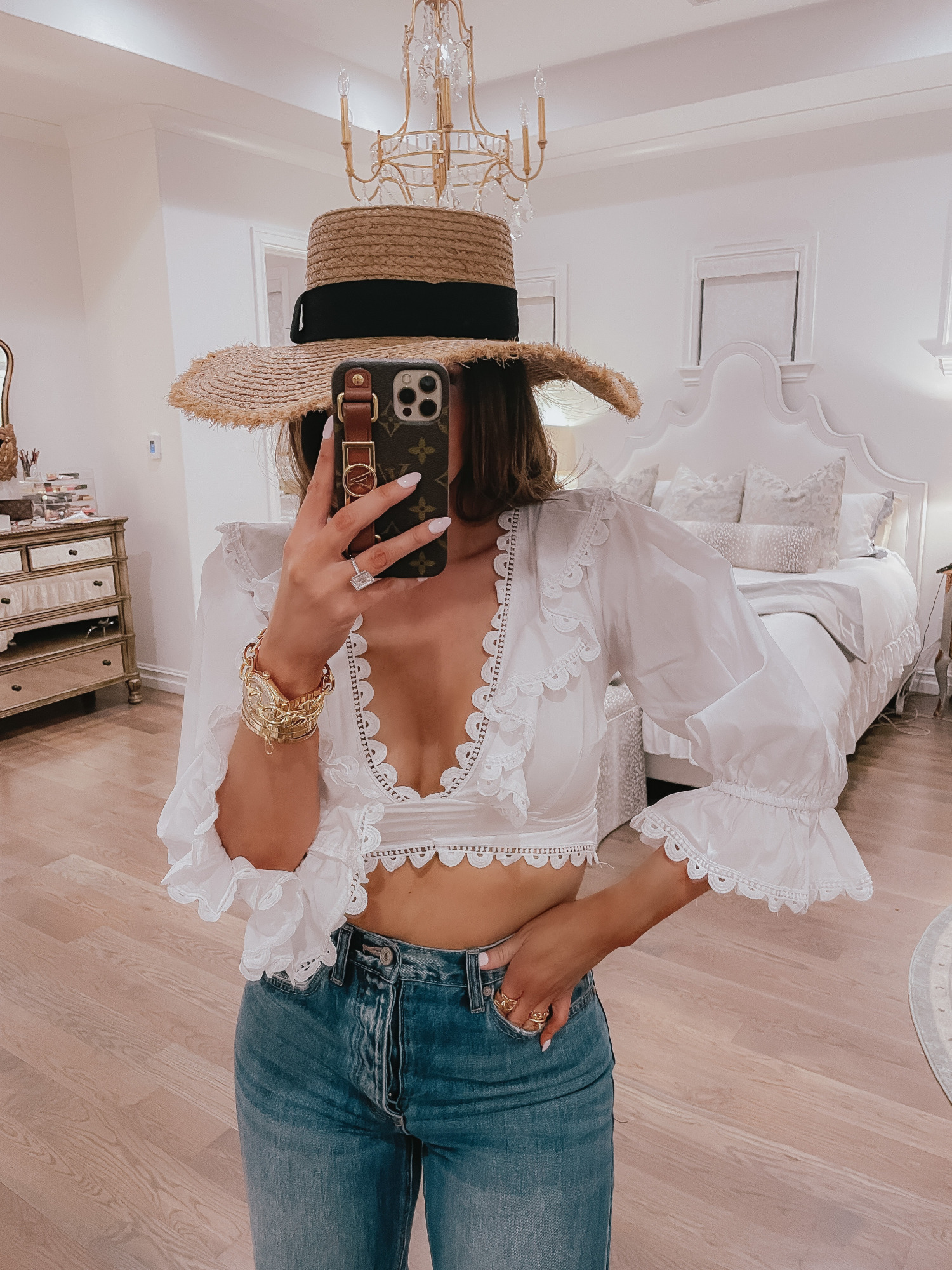 Vici Try On by popular US fashion blog, The Sweetest Thing: image of Emily Gemma wearing a white corset back crop top, jeans, and straw sun hat.