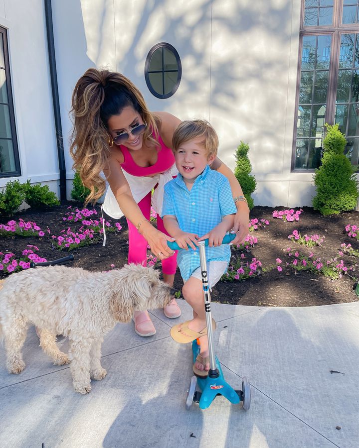 Athletic wear, Zella leggings, Zella sports bra, free people movement jacket, oversized aviator sunglasses, little boys scooter, mom outfit, apl, workout outfits | Instagram Recap by popular US life and style blog, The Sweetest Thing: image of Emily Gemma wearing a pink tank top, pink leggings, and pink sneakers, and standing next to her dog and young son who's standing on a blue micro razor scooter and blue button up short sleeve shirt, tan flip flops, and grey shorts. 